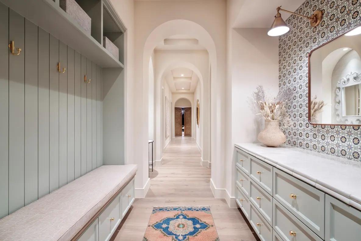 50.-Mud-Room-4-1185x790 A hallway with light wood flooring, mint green furniture,